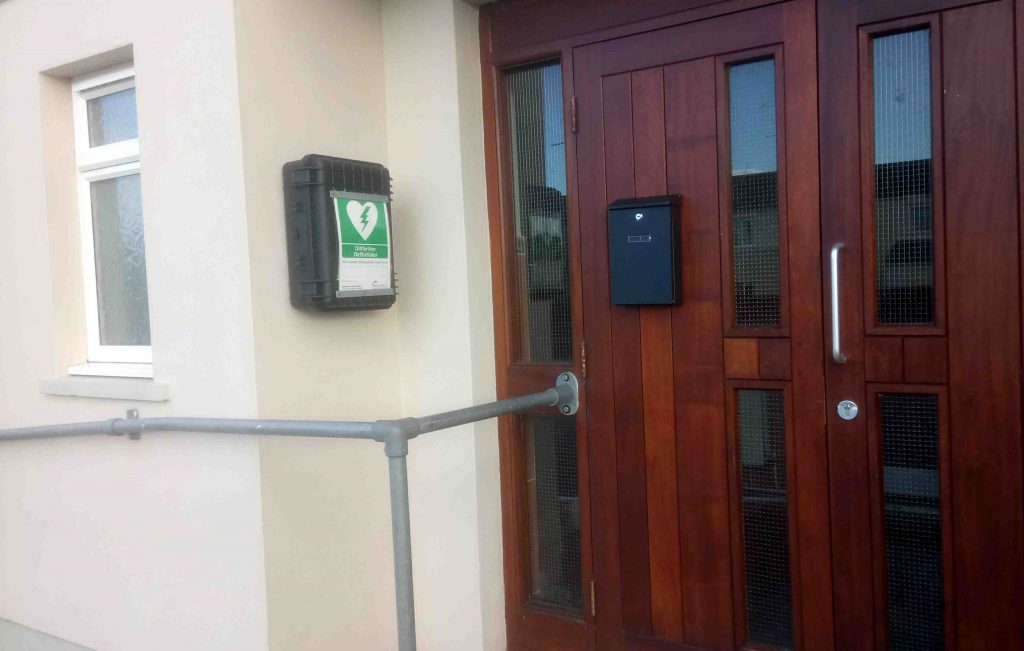Front door of the Hall showing the Defibrillator unit
